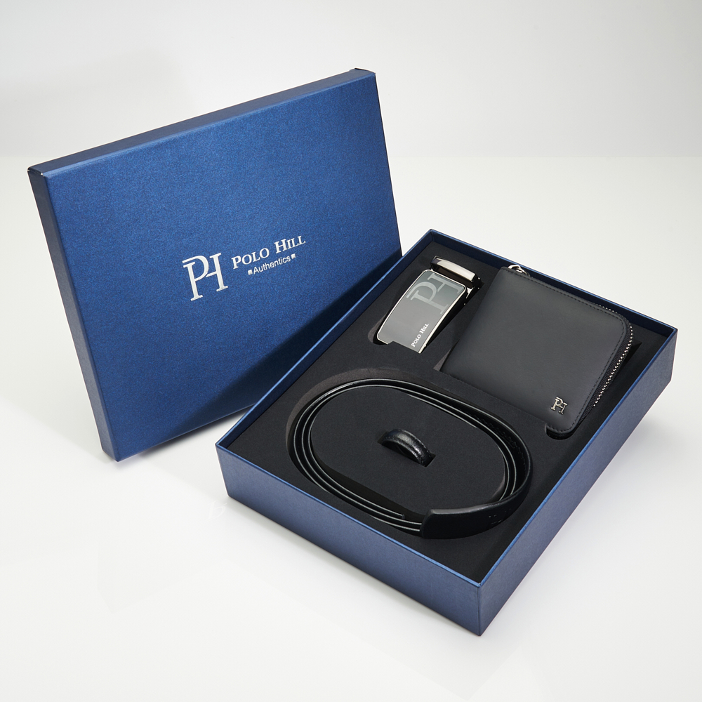 Open POLO HILL gift box with a black leather belt, automatic buckle and RFID wallet on linen